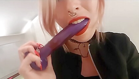 Redheaded babe with tattoo on body rubs clit and sucks toys