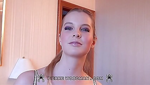 Sexy blonde babe in lingerie and stockings in a tight white dress