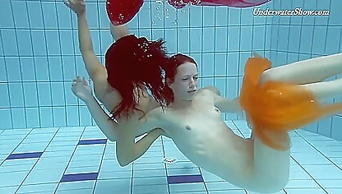 Ebony lesbians show off their sexy bodies in the pool