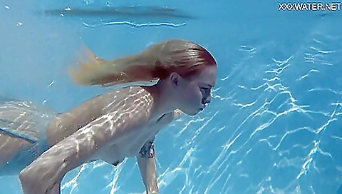 Stunning girl in a bathing suit shows her tits to camera